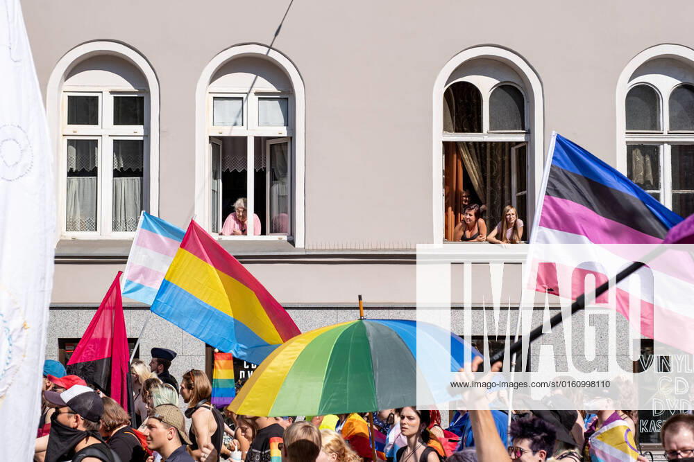 Local residents watch the procession through their windows during the pride rally. 14th pride procession in Wroclaw. It was focused not only on the equality, but also on current events on Ukraine and abortion law restrictions. During the march a group of catholic counter-manifestation appeared, however it was peacefully separated by police. Wroclaw Poland - ZUMAs197 20220611_zab_s197_079