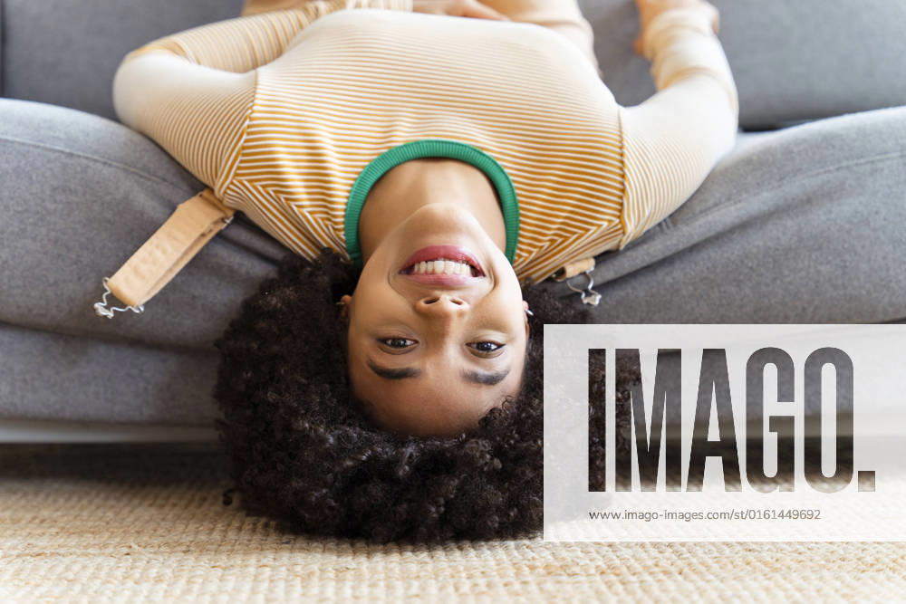 Smiling woman lying on sofa at home model released, Symbolfoto property released, OIPF01748