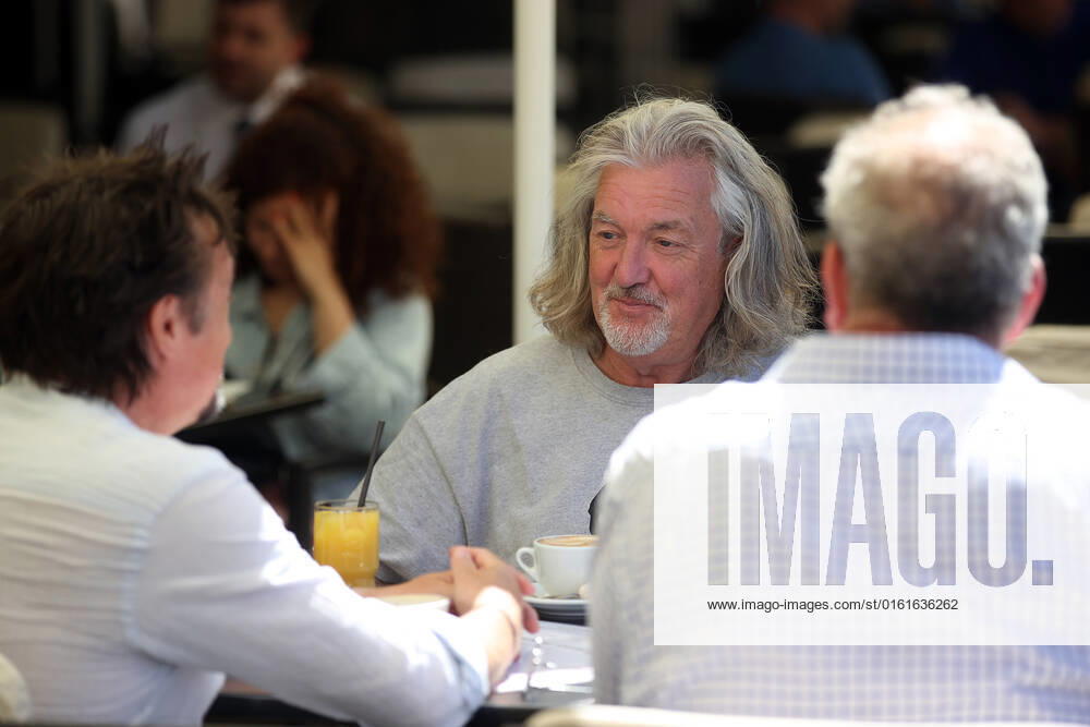 The Grand Tour stars, Jeremy Clarkson, Richard Hammond and James May, take coffee on the Main Square in Cracow, Poland, while on tour filming the show. The Grand Tour is a British motoring television series, created by Jeremy Clarkson, Richard Hammond, James May, and Andy Wilman, made for Amazon exclusively for its online streaming service Amazon Prime Video which premiered in 2016. The programme was conceived in the wake of the departure of Clarkson, Hammond, May and Wilman from the BBC series Top Gear. Krakow Poland - ZUMAs197 20220624_zaa_s197_590