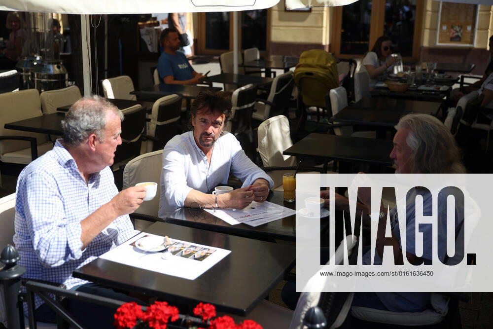 The Grand Tour stars, Jeremy Clarkson, Richard Hammond and James May, take coffee on the Main Square in Cracow, Poland, while on tour filming the show. The Grand Tour is a British motoring television series, created by Jeremy Clarkson, Richard Hammond, James May, and Andy Wilman, made for Amazon exclusively for its online streaming service Amazon Prime Video which premiered in 2016. The programme was conceived in the wake of the departure of Clarkson, Hammond, May and Wilman from the BBC series Top Gear. Krakow Poland - ZUMAs197 20220624_zaa_s197_609