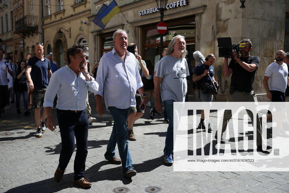 The Grand Tour stars, Jeremy Clarkson, Richard Hammond and James May, walk along the Main Square in Cracow, Poland, while on tour filming the show. The Grand Tour is a British motoring television series, created by Jeremy Clarkson, Richard Hammond, James May, and Andy Wilman, made for Amazon exclusively for its online streaming service Amazon Prime Video which premiered in 2016. The programme was conceived in the wake of the departure of Clarkson, Hammond, May and Wilman from the BBC series Top Gear. Krakow Poland - ZUMAs197 20220624_zaa_s197_601
