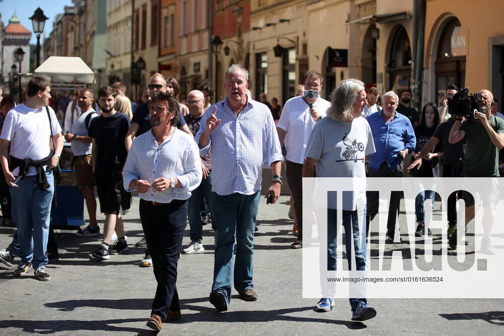 The Grand Tour stars, Jeremy Clarkson, Richard Hammond and James May, walk along the Main Square in Cracow, Poland, while on tour filming the show. The Grand Tour is a British motoring television series, created by Jeremy Clarkson, Richard Hammond, James May, and Andy Wilman, made for Amazon exclusively for its online streaming service Amazon Prime Video which premiered in 2016. The programme was conceived in the wake of the departure of Clarkson, Hammond, May and Wilman from the BBC series Top Gear. Krakow Poland - ZUMAs197 20220624_zaa_s197_604