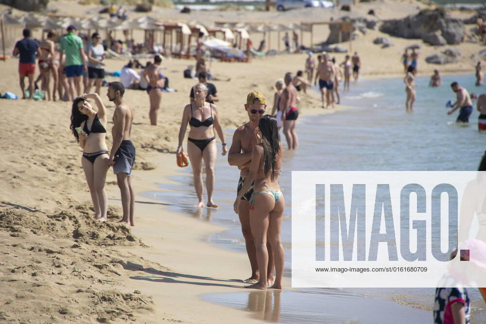 Tourism In Greece - Falassarna Beach In Crete Island Tourism in Greece - The exotic beach of Falassarna at the western side of Crete island. Falasarna bay with 5 beaches with whitish sand and crystal clear transparent tropical turquoise water hosts some of the most famous beaches in Greece, which has been awarded as the best beach of Crete and voted as one of the 10 best beaches in Europe several times in the past. Local people and tourists are seen relaxing, sunbathing, tanning, swimming, doing water sports and walking. Tourism is bouncing back with reservations exceeding the pre-pandemic numbers, putting Greece and the Greek islands on high demand. Tourists travel after the Covid-19 Coronavirus pandemic. Falassarna, Chania, Crete island,