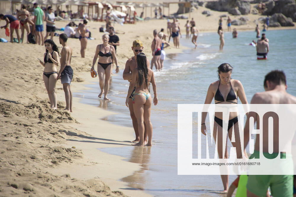 Tourism In Greece - Falassarna Beach In Crete Island Tourism in Greece - The exotic beach of Falassarna at the western side of Crete island. Falasarna bay with 5 beaches with whitish sand and crystal clear transparent tropical turquoise water hosts some of the most famous beaches in Greece, which has been awarded as the best beach of Crete and voted as one of the 10 best beaches in Europe several times in the past. Local people and tourists are seen relaxing, sunbathing, tanning, swimming, doing water sports and walking. Tourism is bouncing back with reservations exceeding the pre-pandemic numbers, putting Greece and the Greek islands on high demand. Tourists travel after the Covid-19 Coronavirus pandemic. Falassarna, Chania, Crete island,