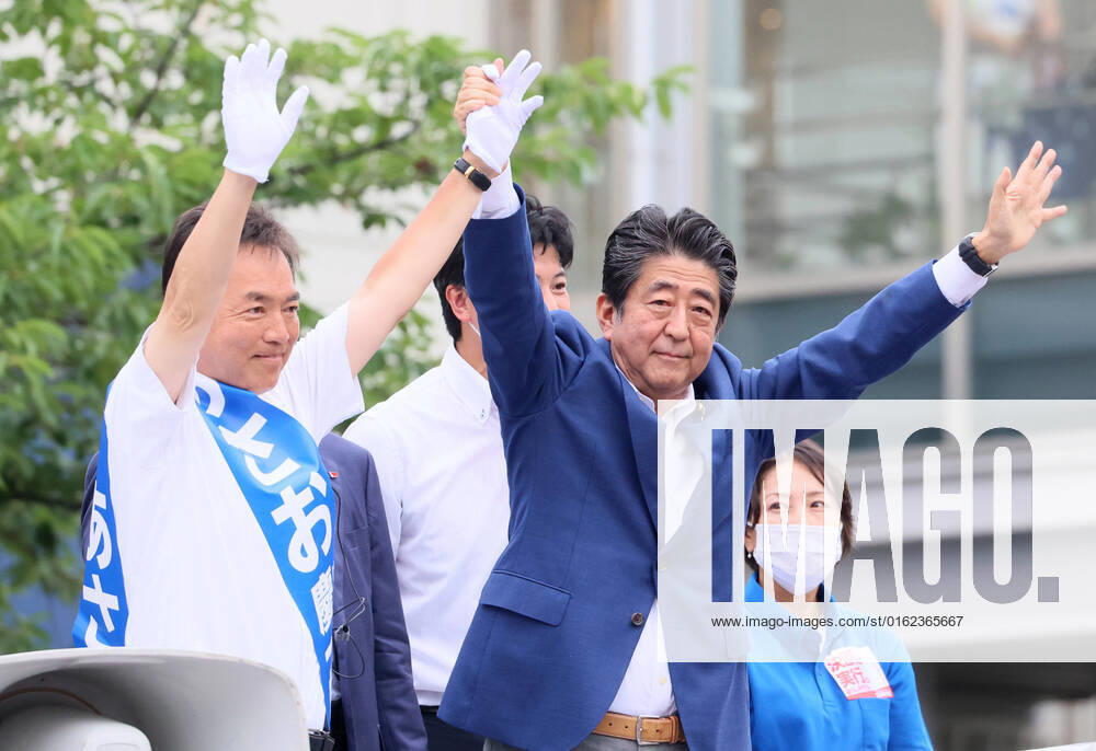 Yokohama, Japan - Former Japanese Prime Minister Shinzo Abe (C) raises arms with the ruling Liberal Democratic Party candidate Keiichiro Asao (L) after he delivered a campaign speech for the Upper House election in Yokohama, suburban Tokyo on Wednesday, July 6, 2022. The Upper House election will be held on July 10. , aflo_192824600.jpg,