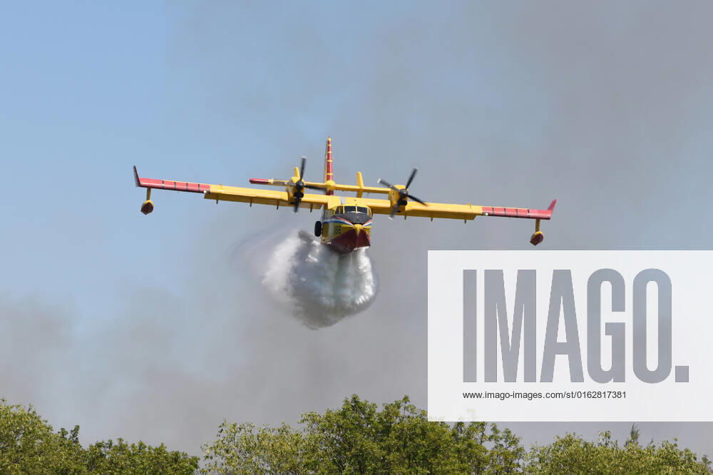 PXL_A fire near Vodice, Croatia Fire in an open area near the Velika Mrdakovica archaeological site in the Vodice hinterland, Croatia on July 13, 2022. About 30 firefighters with a dozen vehicles are on the ground, and two Canadairs joined the ground forces in extinguishing the fire. There are pine forests above, low vegetation, and endangered buildings. HrvojexJelavic PIXSELL