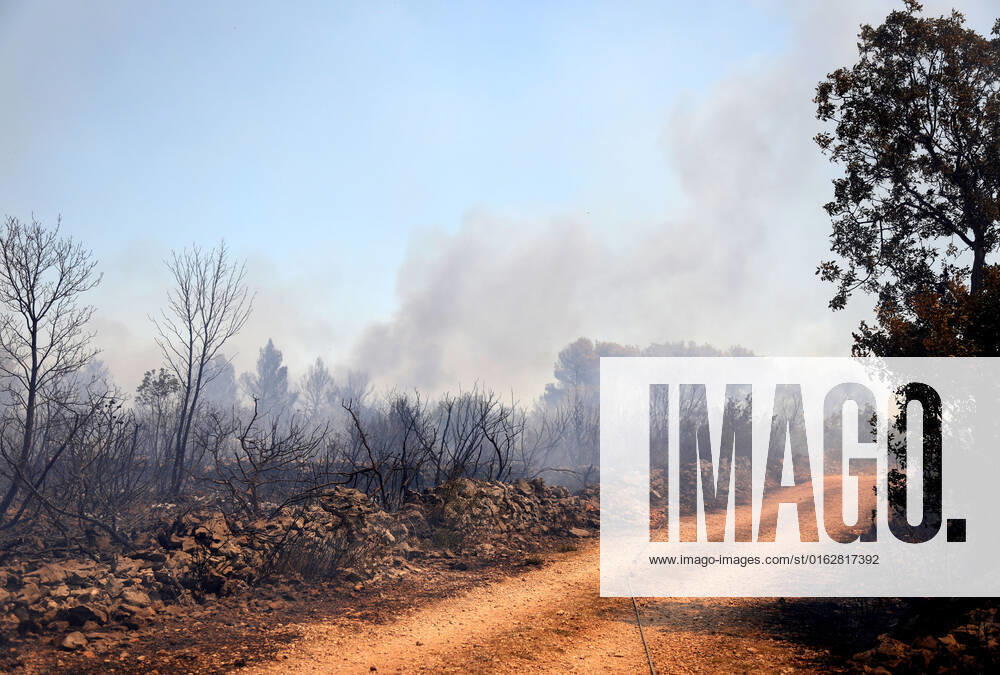 PXL_A fire near Vodice, Croatia Fire in an open area near the Velika Mrdakovica archaeological site in the Vodice hinterland, Croatia on July 13, 2022. About 30 firefighters with a dozen vehicles are on the ground, and two Canadairs joined the ground forces in extinguishing the fire. There are pine forests above, low vegetation, and endangered buildings. DuskoxJaramaz PIXSELL