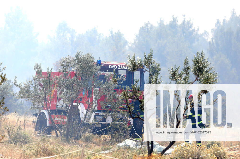 PXL_A fire near Vodice, Croatia Fire in an open area near the Velika Mrdakovica archaeological site in the Vodice hinterland, Croatia on July 13, 2022. About 30 firefighters with a dozen vehicles are on the ground, and two Canadairs joined the ground forces in extinguishing the fire. There are pine forests above, low vegetation, and endangered buildings. DuskoxJaramaz PIXSELL