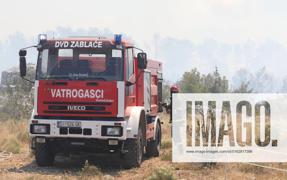 PXL_A fire near Vodice, Croatia Fire in an open area near the Velika Mrdakovica archaeological site in the Vodice hinterland, Croatia on July 13, 2022. About 30 firefighters with a dozen vehicles are on the ground, and two Canadairs joined the ground forces in extinguishing the fire. There are pine forests above, low vegetation, and endangered buildings. DuskoxJaramaz PIXSELL