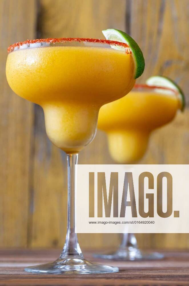 Frozen Mango Margarita cocktails, Glasses of Frozen Mango Margarita cocktails garnished with paprika salt rim, Glasses of Frozen Mango Margarita cocktails garnished with paprika salt rim, 10.09.2020,