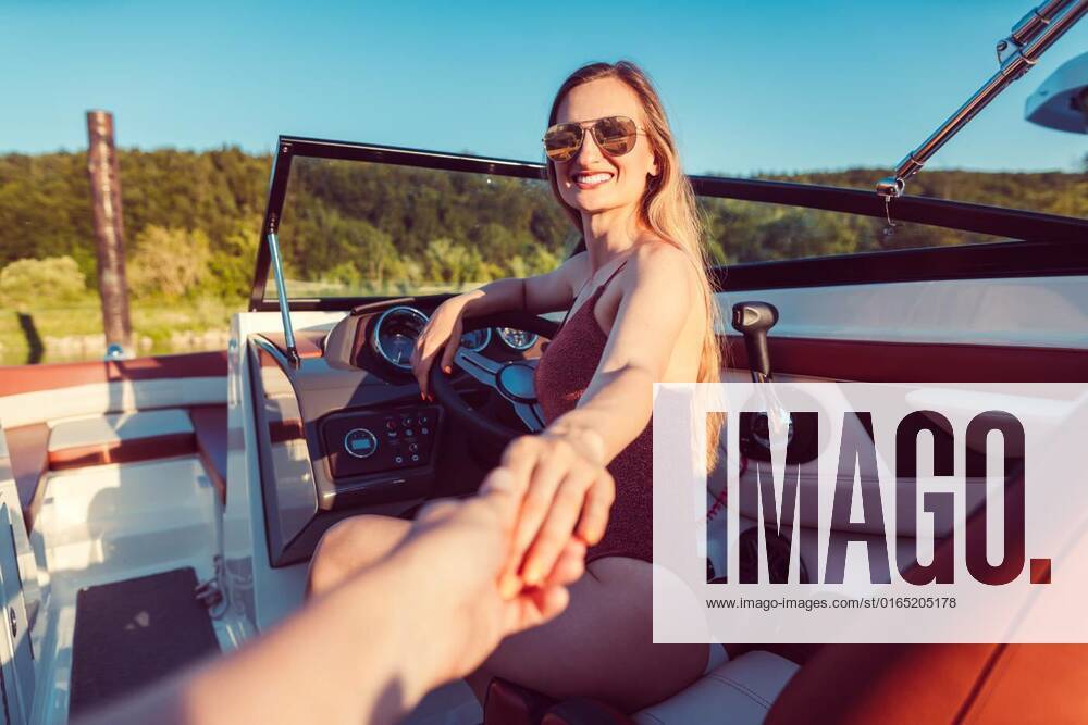 Woman inviting her friend to have a ride on the river yacht, Woman inviting her friend to have a ride on the river yacht, pov shot model released, Symbolfoto , 20.07.2020,