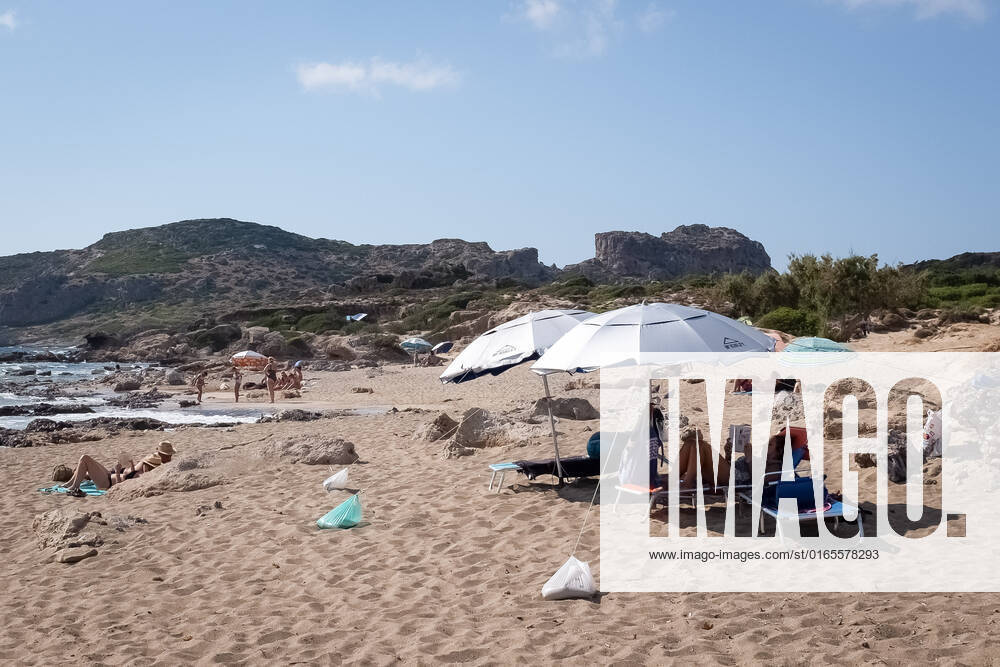 Tourism In Greece - Falassarna Beach In Crete Island People are enjoy their time at Falassarna beach near Chania, Crete Island, Greece on August 14, 2022. Falassarna is located 59 kilometers west of Chania. Today is one of the most famous destinations in Crete, for its beaches and for reasons of ecological interest. Falassarna Greece