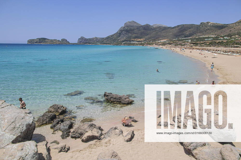 Tourism In Greece - Falassarna Beach In Crete Island Tourism in Greece - The exotic beach of Falassarna at the western side of Crete island during a high-temperature day, heatwave. Falasarna bay with 5 beaches made of whitish sand and crystal clear transparent tropical turquoise water hosts some of the most famous beaches in Greece, which has been awarded multiple times as the best beach of Crete and voted as one of the 10 best beaches in Europe several times in the past. Local people and tourists are seen relaxing, sunbathing, tanning, swimming, doing water sports and walking. Tourism is bouncing back with reservations overpassing the pre-pandemic numbers, putting Greece and the Greek islands on high demand. Tourists travel after the Covid