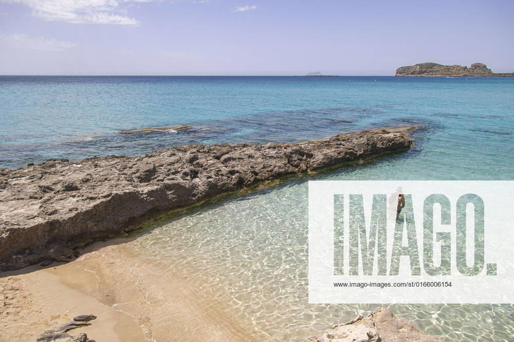 Tourism In Greece - Falassarna Beach In Crete Island Tourism in Greece - The exotic beach of Falassarna at the western side of Crete island during a high-temperature day, heatwave. Falasarna bay with 5 beaches made of whitish sand and crystal clear transparent tropical turquoise water hosts some of the most famous beaches in Greece, which has been awarded multiple times as the best beach of Crete and voted as one of the 10 best beaches in Europe several times in the past. Local people and tourists are seen relaxing, sunbathing, tanning, swimming, doing water sports and walking. Tourism is bouncing back with reservations overpassing the pre-pandemic numbers, putting Greece and the Greek islands on high demand. Tourists travel after the Covid