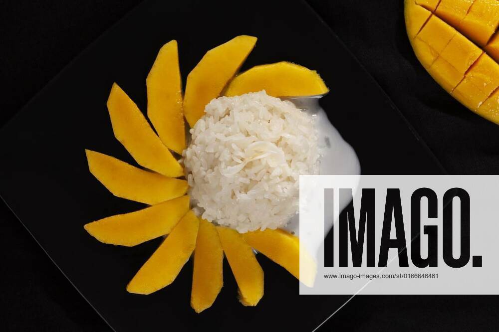 Famous Thai dessert , Mango with sticky rice and coconut milk., Khao niew mamuang, Mango sticky rice, delicious Thai dessert on black background from above., Khao niew mamuang, Mango sticky rice, delicious Thai dessert on black background from above., 16.03.2021,