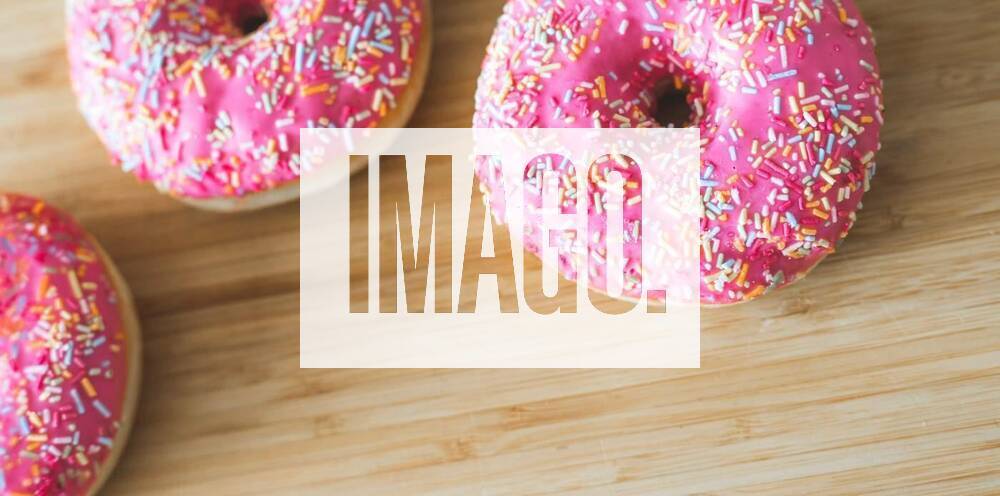 Sugar addiction: Close up of sugar sprinkled pink donut, Sugar sprinkled pink donut on wooden plate, 03.04.2021,