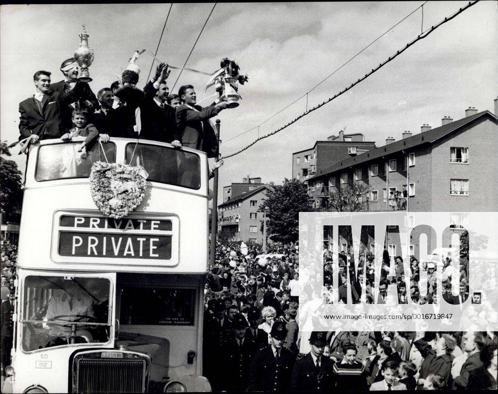 Tottenham Fetes Their Victorious Football Team: The Cup Winning - League Champion Football Team- Tottenham Hotspur were feted by the Mayor and Corporation and the of Tottenham yesterday - at the Town hall and is the streets of the brought. Picture Shows: Members of the Tottenham Hotspur Team - hold up their F.A. Cup from top of their bus League Championship Cup from top of their bus during their tour of Tottenham Yesterday. - ZUMAk09