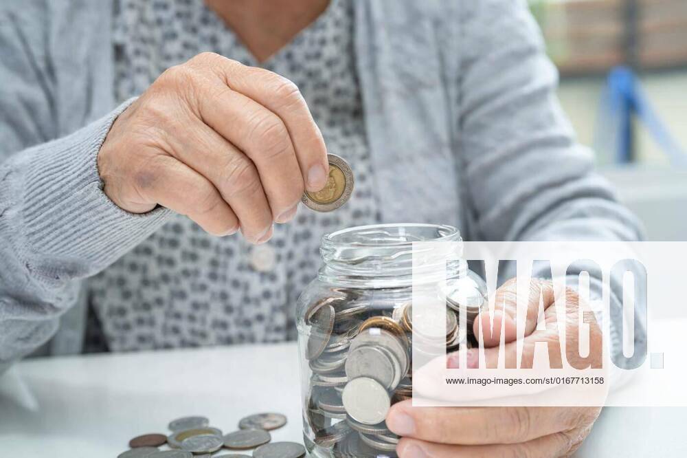 Asian senior or elderly old lady woman holding counting coin money in glass jar. Poverty, saving problem in retirement., Asian senior or elderly old lady woman holding counting coin money in glass jar. Poverty, saving problem in retirement., Asian senior or elderly old lady woman holding counting coin money in glass jar. Poverty, saving problem in retirement., 21.12.2021,