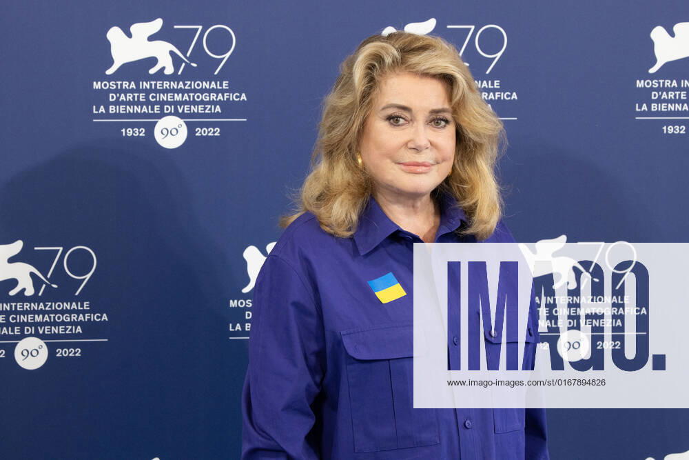 French actress Catherine Deneuve, wearing a flag of Ukraine on her shirt, poses on August 31, 2022, during a photocall for the Golden Lion for Lifetime Achievement she is to be awarded, on the opening day of the 79th Venice International Film Festival at Venice Lido. Â Photo: Cinzia Camela.
