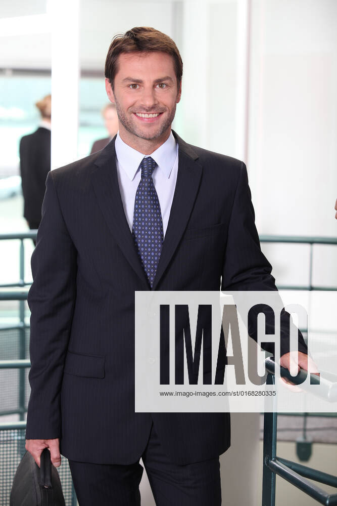 Business man standing in office, model released, , 5663578.jpg, _ M_Roussiau_Nicolas_190510, 35, age, aged, associates, board, boss, briefcase, business, businessman, businesspeople, businesswoman, caucasian, clothes, colleague, conference, confident, consultant, consulting, cooperation, employee, enterprise, European, executive, foreground, group, leader, leadership, male, man, management, manager, middle, office, partners, partnership, portrait, room, smiling, strategy, suit, team, vertical, work, workplace,