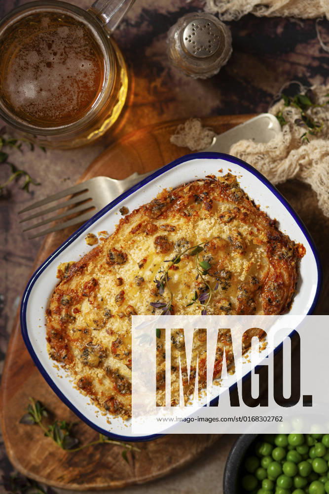 IMAGO Creative, Food, Pot Pie An individual steak and blue cheese pie topped with mashed potatoes and served with a glass of beer. An individual steak and blue cheese pie topped with mashed potatoes and served with a glass of beer.