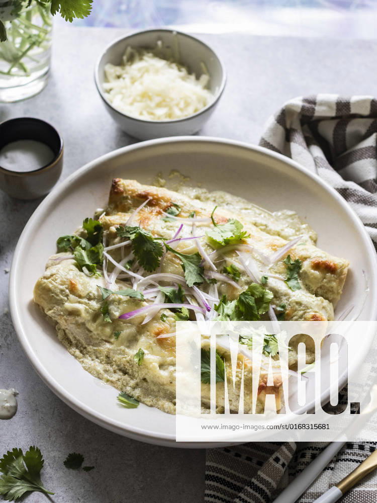 IMAGO Creative, Food, Enchiladas Cheesy enchiladas filled with chredded chicken and black beans, served with creamy sauce
