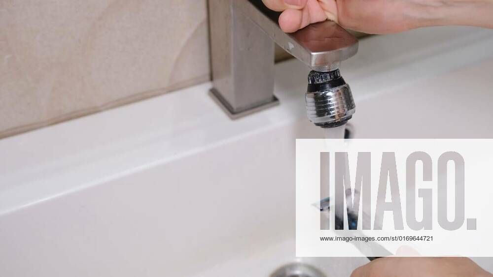 Cleaning shaving razor in bathroom sink. Rinsing off razor with water., Cleaning shaving razor in bathroom sink. Rinsing off razor with water, Cleaning shaving razor in bathroom sink. Rinsing off razor with water, 15.08.2022,