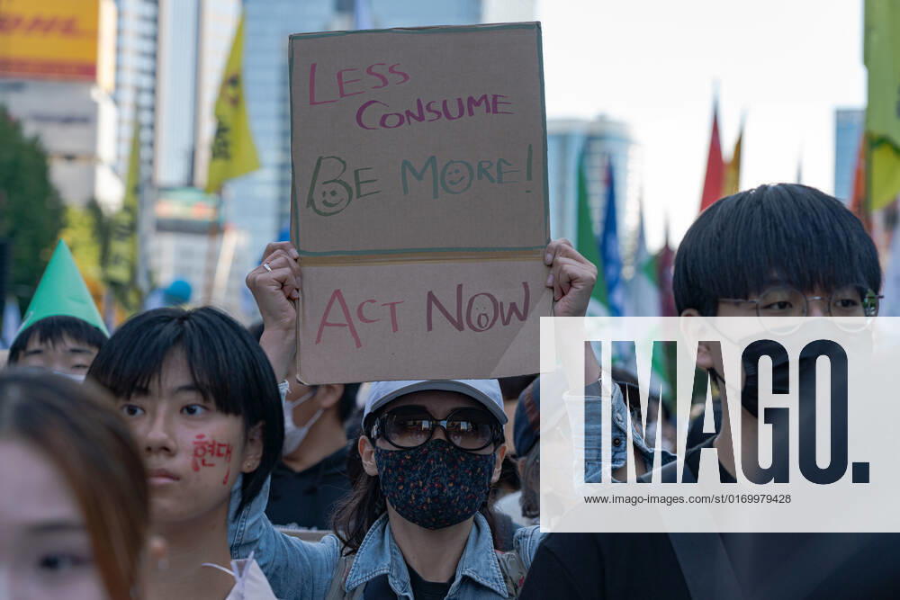 Climate Justice March In Seoul A protester holds a placard saying Less Consume, Be More! Act Now. at Climate Justice March around Gwanghwamun area on September 24, 2022 in Seoul, South Korea. The demonstration demanded the government to stop using Fossil Energy system and climate justice. About 10,000 people by The Police s estimate (35,000 people by The Organizer s estimate) gathered at the demonstration on the day. Seoul South Korea