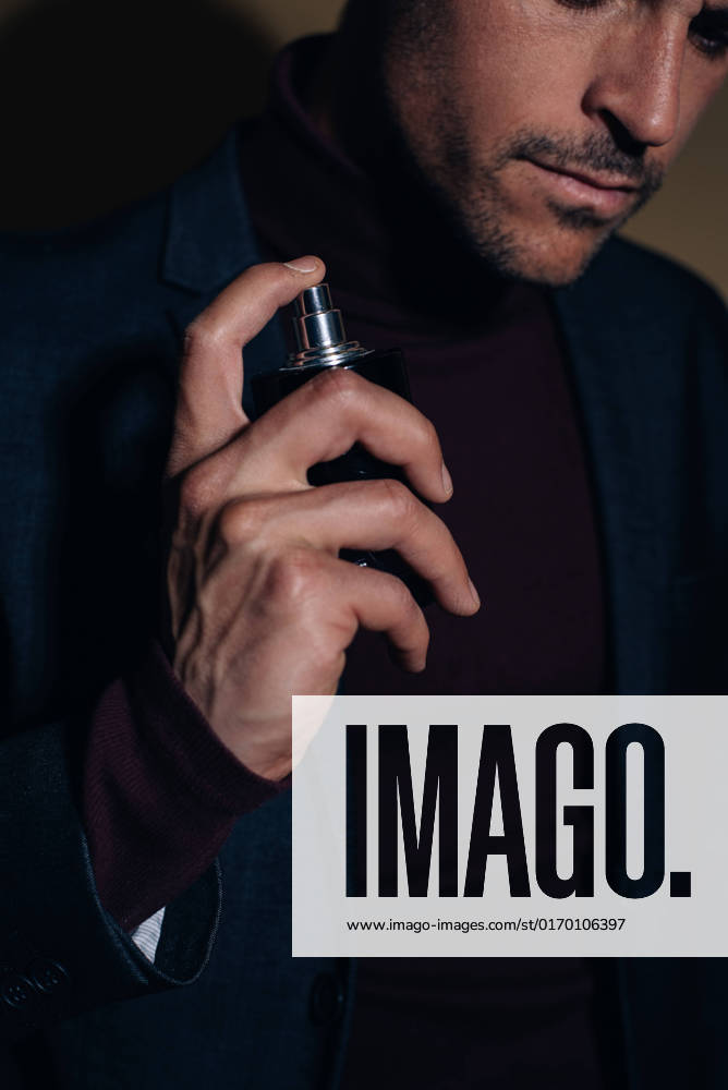 Young business man in a studio applying perfume, Model released DavidPrado_NachoStudio_6
