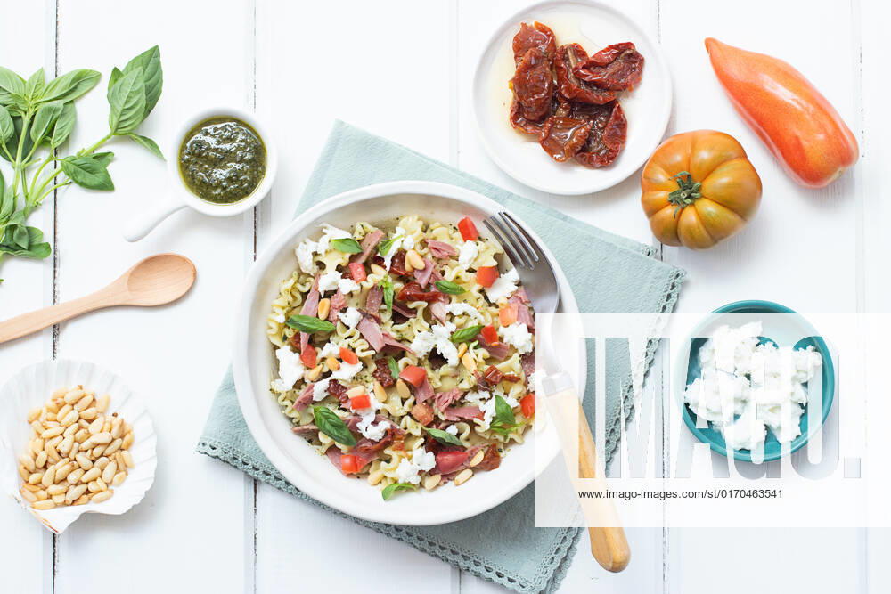 From above appetizing salad mixed with various fresh ingredients on wooden white table OlgaVila_ID988_37173_003