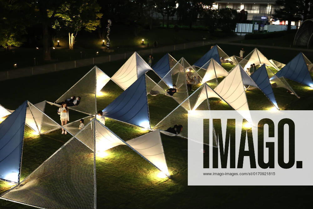 Tokyo, Japan - A large installation Sea Hammock formed by tarps and fishnets created by Japanese architect Yuko Nagayama is displayed on the lawn field as a part of the Tokyo Midtown Design Touch 2022 in Tokyo on Friday, October 14, 2022. An annual design event with the theme of Design for Sustainable Future started at the Tokyo Midtown through November 3. , aflo_201255366.jpg,