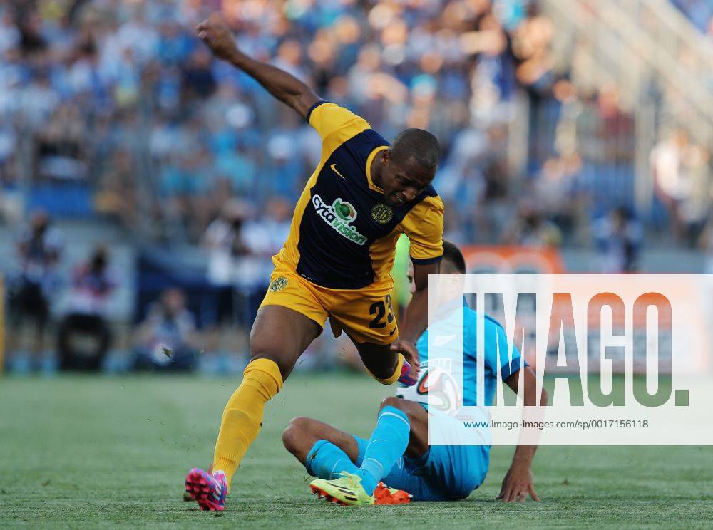 ITAR-TASS: ST. PETERSBURG, RUSSIA. AUGUST 6, 2014. AEL s Carlitos (L) and Zenit s Domenico Criscito fight for the ball in their UEFA Champions League 3rd Qualifying Round match at the Petrovsky Stadium in St. Petersburg. premiumd 20211413