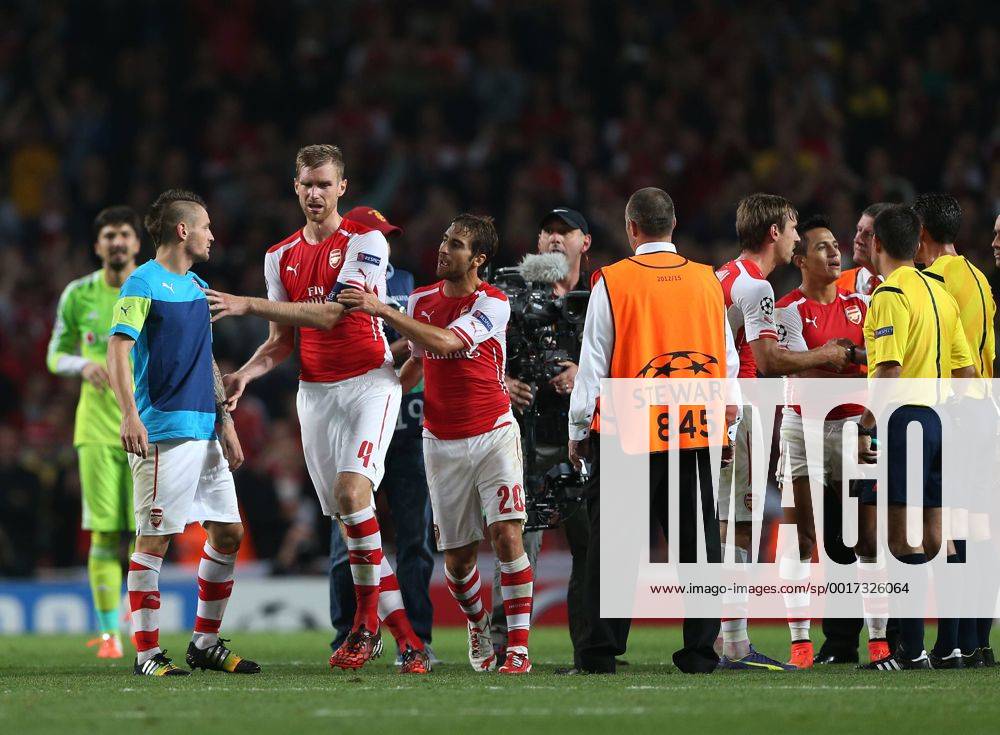 Arsenal s Mathieu Debuchy comes on to speak to referee Pedro Proenca at the final whistle - UEFA Champions League, Play-off Second Leg - Emirates Stadium - England - 27th August 2014 - Picture David Klein Sportimage .