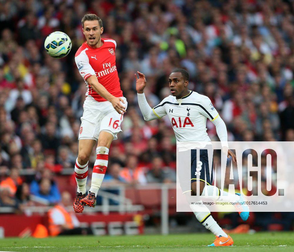 Arsenal s Aaron Ramsey tussles with Tottenham s Danny Rose - Barclays Premier League - Arsenal vs Tottenham Hotspur - Emirates Stadium - England - 27th September 2014 - .