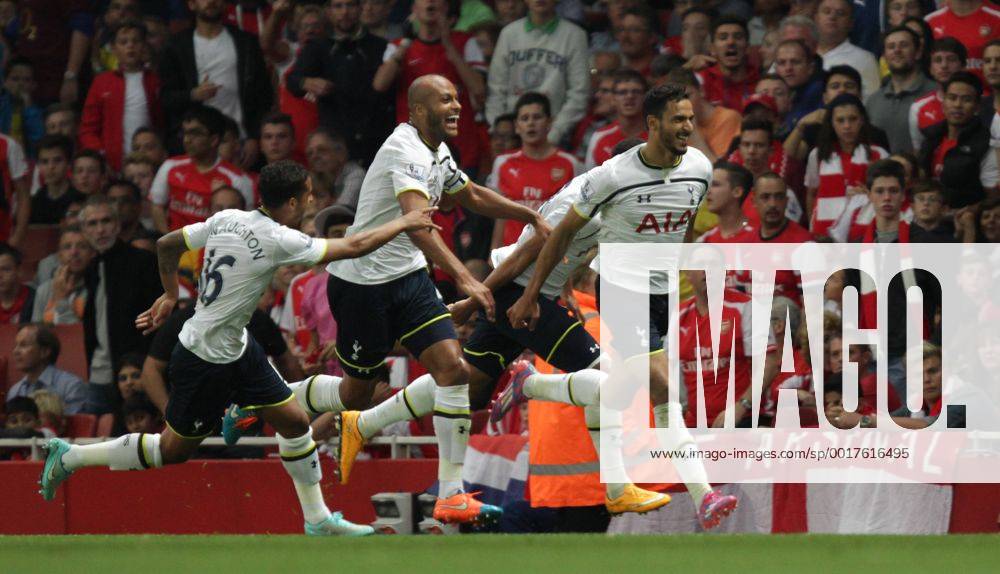 Arsenal FC London - Tottenham Hotspur Nacer Chadli (TH) celebrates scoring a goal for Tottenham, as Younes Kaboul (TH) follows behind. 0-1