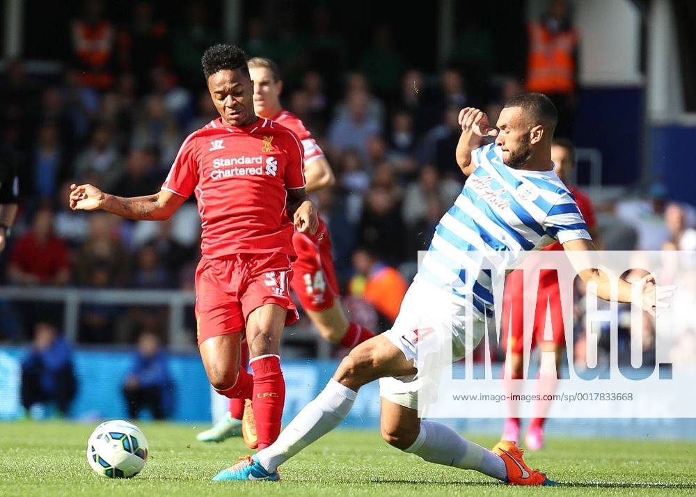 Football - 2014 2015 Premier League - Queens Park Rangers vs Liverpool, Steven Caulker of Queens Park Rangers gets a foot to the ball before Raheem Sterling of Liverpool FC at Loftus Road Colorsport Daniel Bearham QPR_LIV