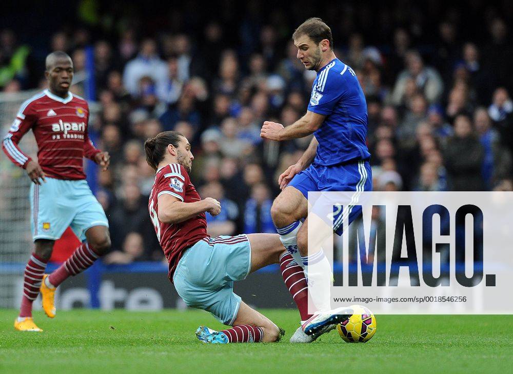 Andy Carroll of West Ham United tackles Branislav Ivanovic of Chelsea - Barclays Premier League - Chelsea vs West Ham United - Stamford Bridge Stadium - London - England - 26th December 2014 - Pic Robin Parker Sportimage . DSC_7765