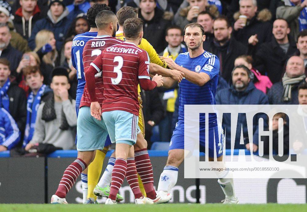 Football - 2014 2015 Premier League - Chelsea vs. West Ham United Chelsea s Branislav Ivanovic is challenged by West ham players, accusing him of diving at Stamford Bridge. COLORSPORT ANDREW COWIE