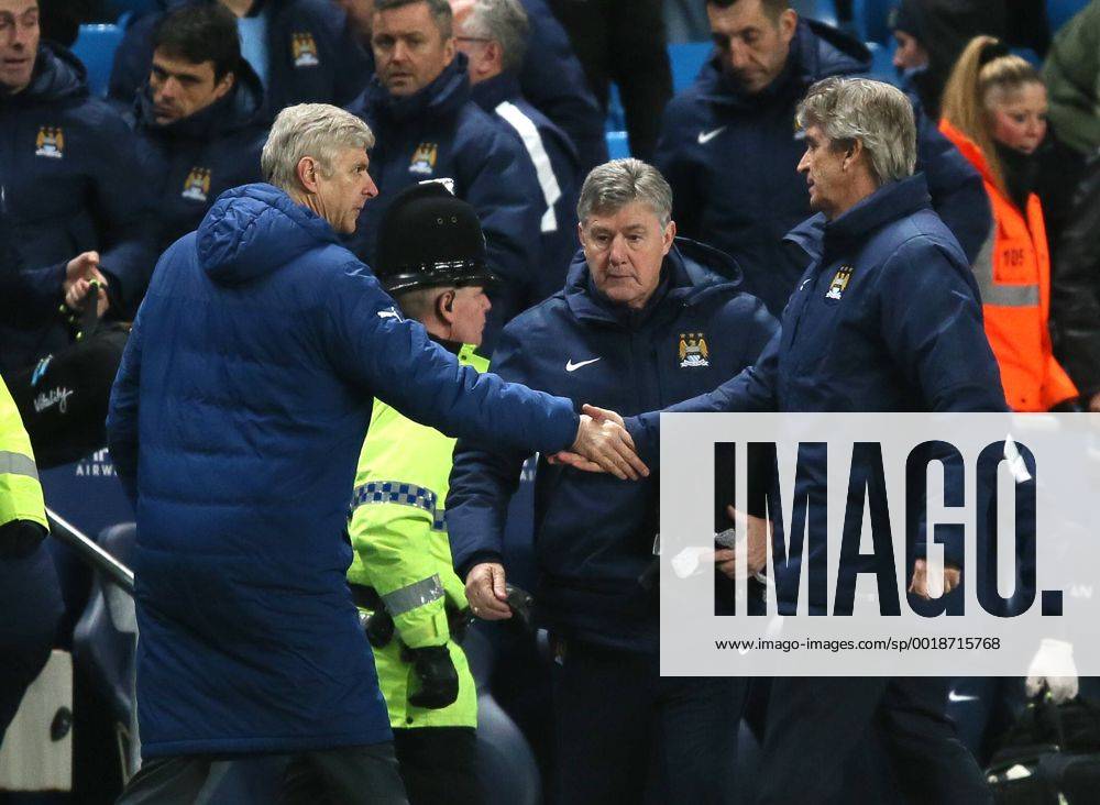 Arsene Wenger manager of Arsenal shakes hands with Manuel Pellegrini manager of Manchester City at the end of the match - Barclays Premier League - Manchester City vs Arsenal - Etihad Stadium - Manchester - England - 18th January 2015 - Picture Simon Bellis Sportimage .