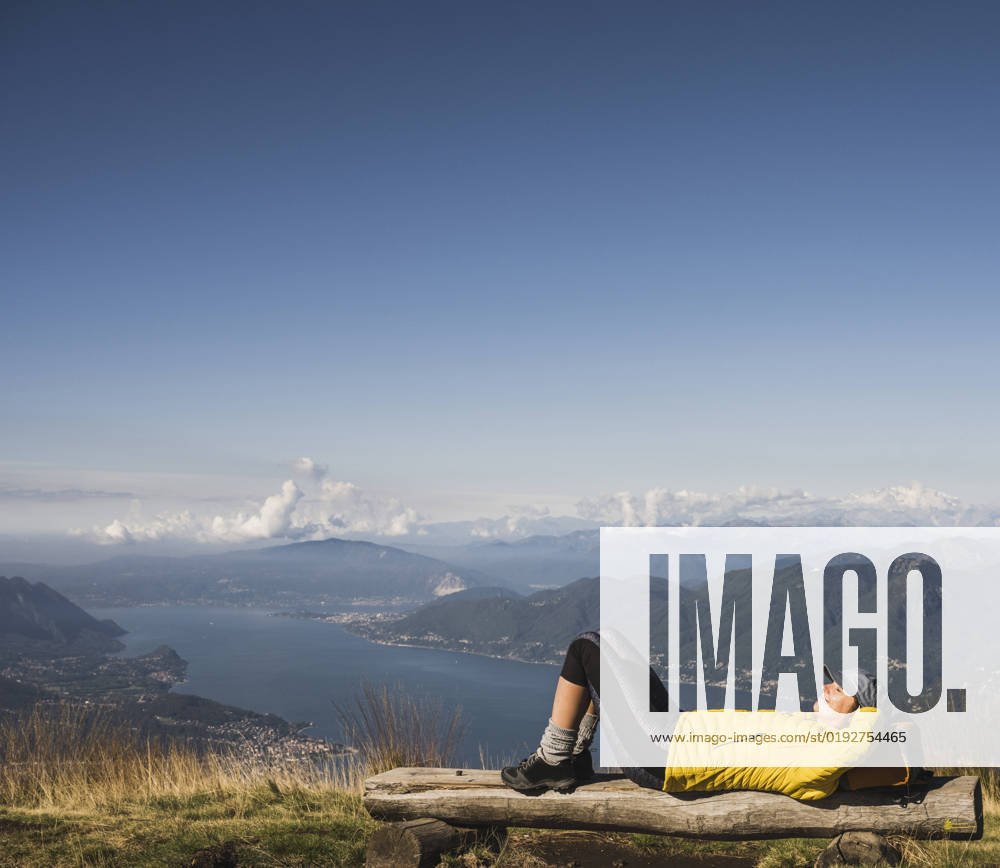 Mature woman wearing cap relaxing on bench model released, Symbolfoto, UUF27632