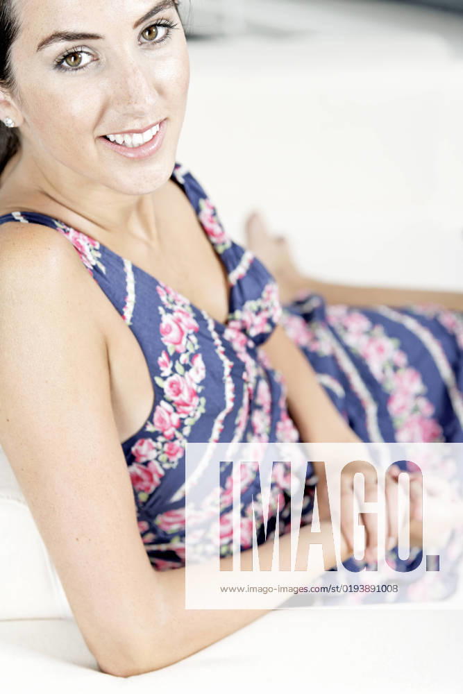Beautiful young woman wearing a blue summer dress resting on her sofa at home, model released, , 6544350.jpg, attractive, beautiful, blue, cheerful, fashion, female, happy, home, lifestyle, modern, relaxing, resting, sitting, smiling, sofa, summer dress, woman, young adult,