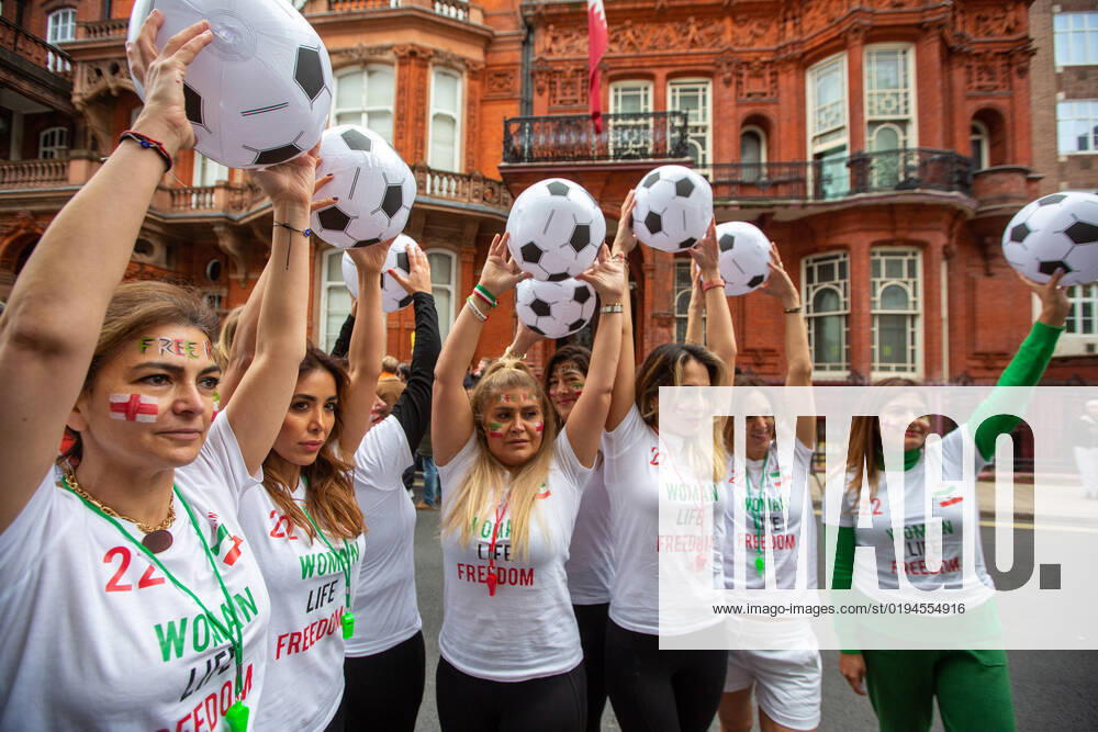 Iranian women wearing football shirts and holding balls join LGBT demonstration outside the Embassy of Qatar. protesting the FIFA Wold Cup host countryâ€⠢s anti-gay laws, oppression of women and abuse of migrant workers. London United Kingdom - ZUMAs262 20221119_zip_s262_046