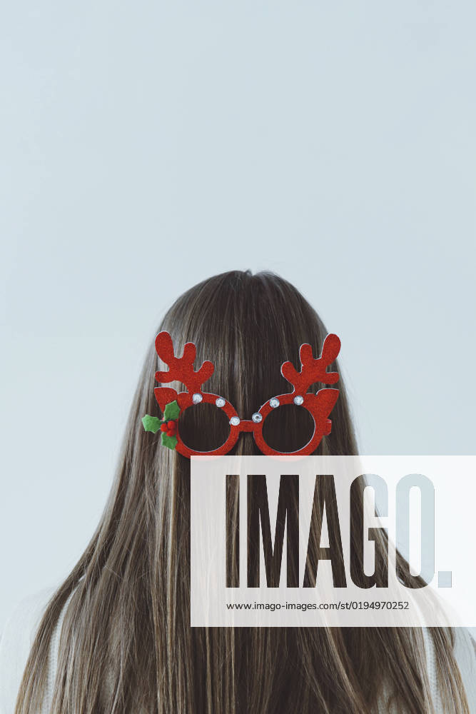Girl with long hair wearing reindeer antler glasses on back of head model released, Symbolfoto, IEF00252