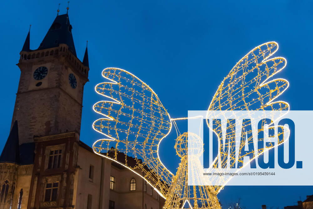 Illuminated Angel decoration and tower of Old town hall as seen on the traditional Christmas market at Old town Square in Prague. Prague Czech Republic - ZUMAs197 20221128_zaa_s197_276