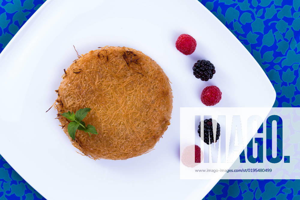 IMAGO Creative, Food, Künefe Turkish dessert kunefe on a blue table cloth with mint leaves and berries , 9359294.jpg, Dough, Food, Freshness, Ingredient, Macro, Plate, appetizer, arabic, bakery, baking, berries, blackberries, butter, cheese, cloth, cooking, cuisine, delicious, dessert, dinner, east, ethnic, fillo, fork, golden, gourmet, greek, hot, kadaifi, kadayif, kunafeh, kunefe, leaves, lebanese, lunch, meal, mediterranean, middle eastern, mint, pastry, raspberry, restaurant, shredded, strawberry, sweet, syrup, table, traditional, turkish,