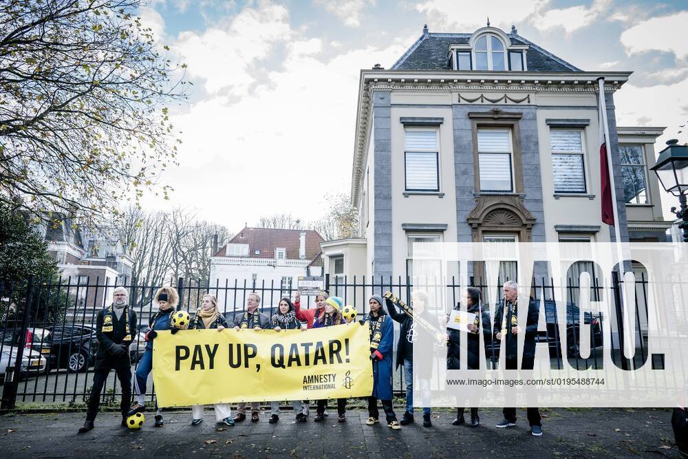 THE HAGUE - Members of Amnesty International prior to offering signatures to the embassy of Qatar. The human rights organization calls on Qatar and FIFA to compensate the affected migrant workers who made the World Cup possible. ANP BART MAAT netherlands out - belgium out