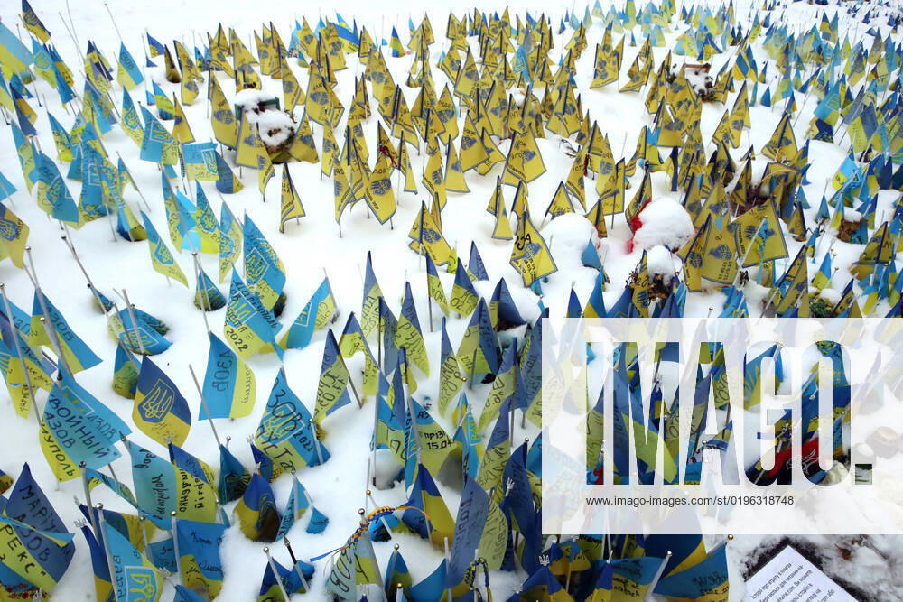 KYIV, UKRAINE - DECEMBER 9, 2022 - The miniature flags of Ukraine bearing the noms de guerre and dates of death of the Ukrainian military personnel who defended Mariupol from Russian occupiers are seen on the snow-covered lawn in Maidan Nezalezhnosti, Kyiv, capital of Ukraine. Ukrainian flags in Maidan Nezalezhnosti