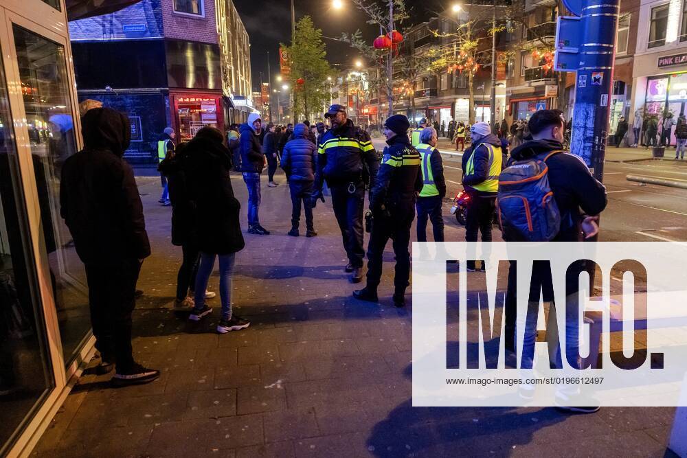 ROTTERDAM - Volunteers and police with Moroccan football supporters after the semi-final match between Morocco and France at the World Cup in Qatar. ANP JEFFREY GROENEWEG netherlands out - belgium out