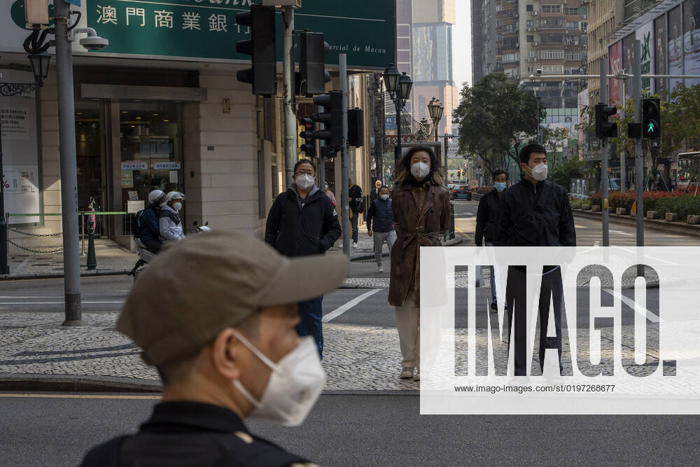Macau Covid-19 Measures Pedestrian wearing face masks waiting to cross the street on December 29, 2022 in Macau, China. Macau Macau