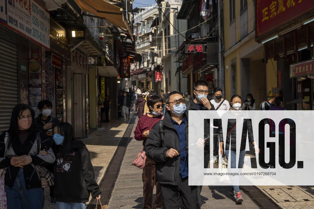 Daily Life In Macau People wearing face masks walking in a street at a popular tourist district on December 29, 2022 in Macau, China. Macau Macau